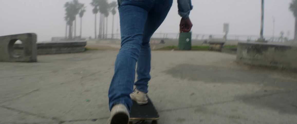 Woman rides on a skateboard and moves forward by pushing one foot on the ground