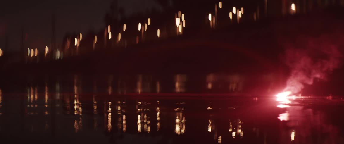 Red emergency flare on the floor while someone walks by