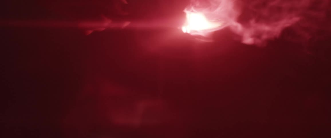 A person shakes a lit flare with it burns