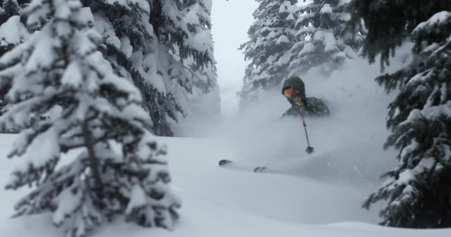 A skier blows up deep powder
