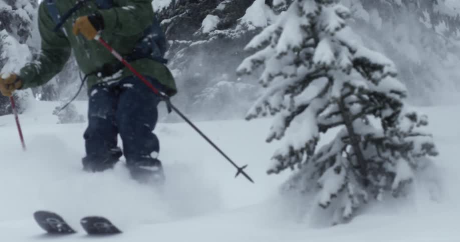 The person skis down the hill