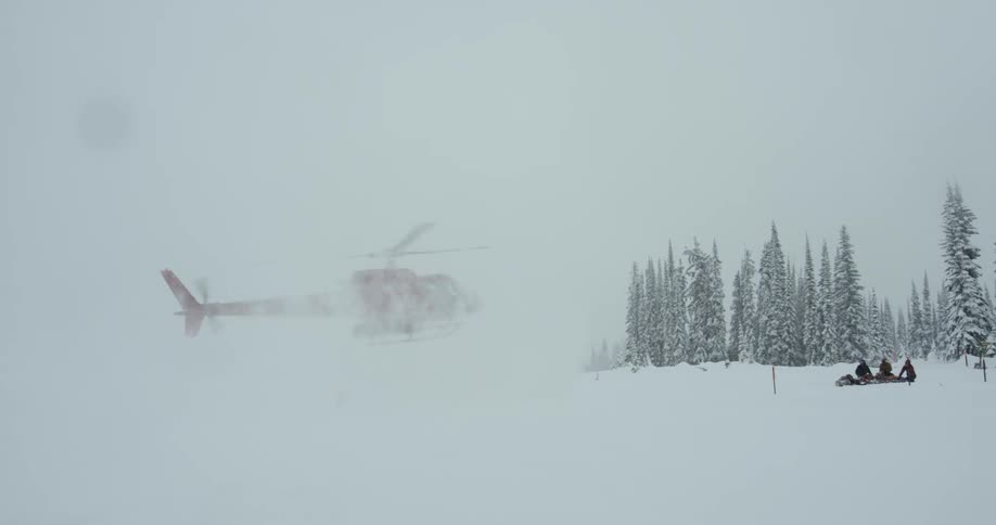 A helicopter is landing by a house in winter
