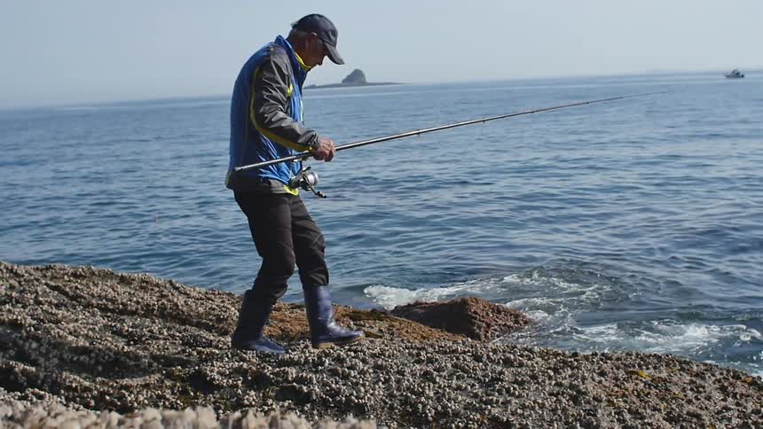 A man fishes on the coast