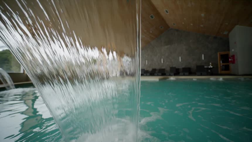 Water pours into an indoor swimming pool