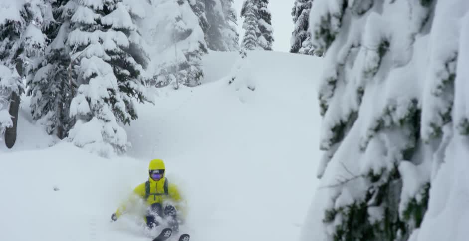 A skier does a big jump into powder