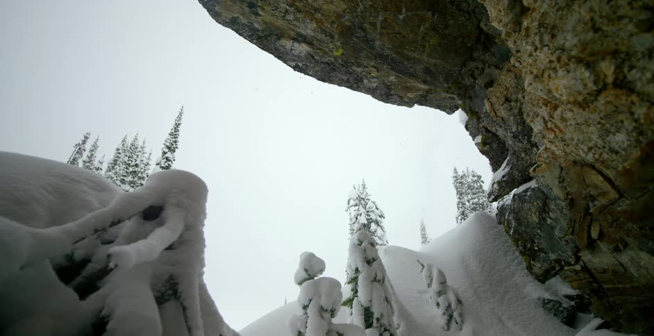 Skier jumps over a snow cliff