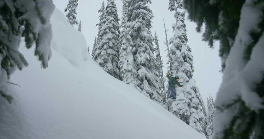 A skier does a 360 spin into deep powder