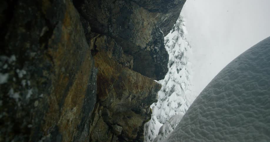 A skier jumping over a snowy cave