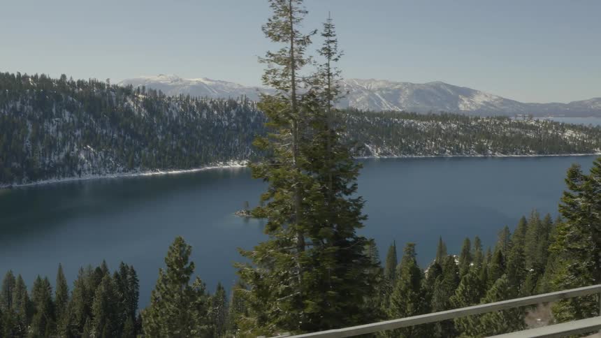 A lakes seen through trees while traveling