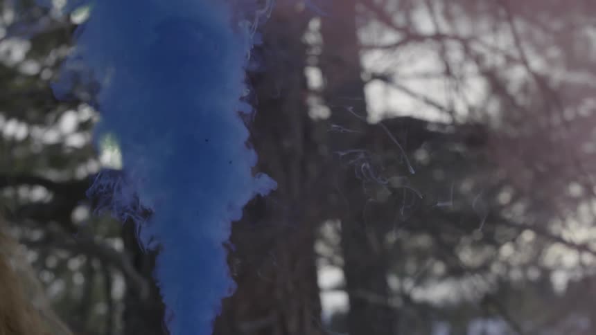 A blue smoke bomb in the forest