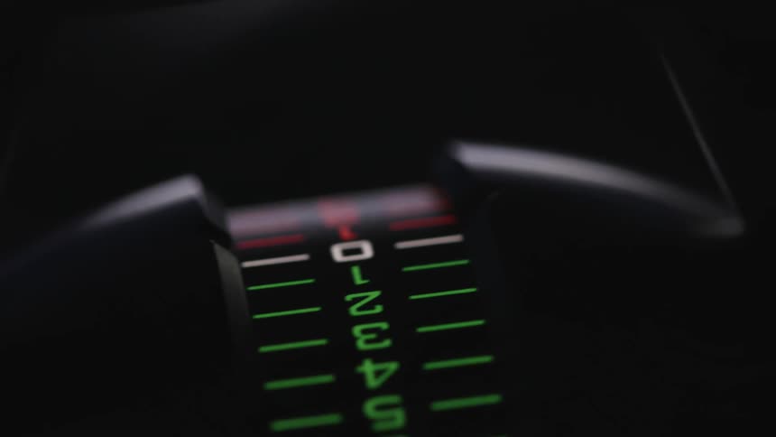 A dial with a number scale reflects light