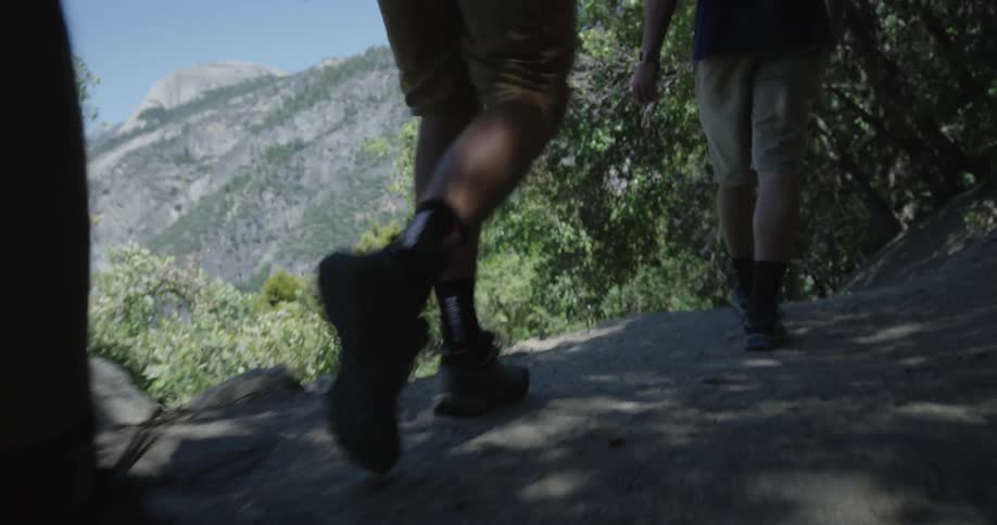 Men walking on a trail in a natural setting