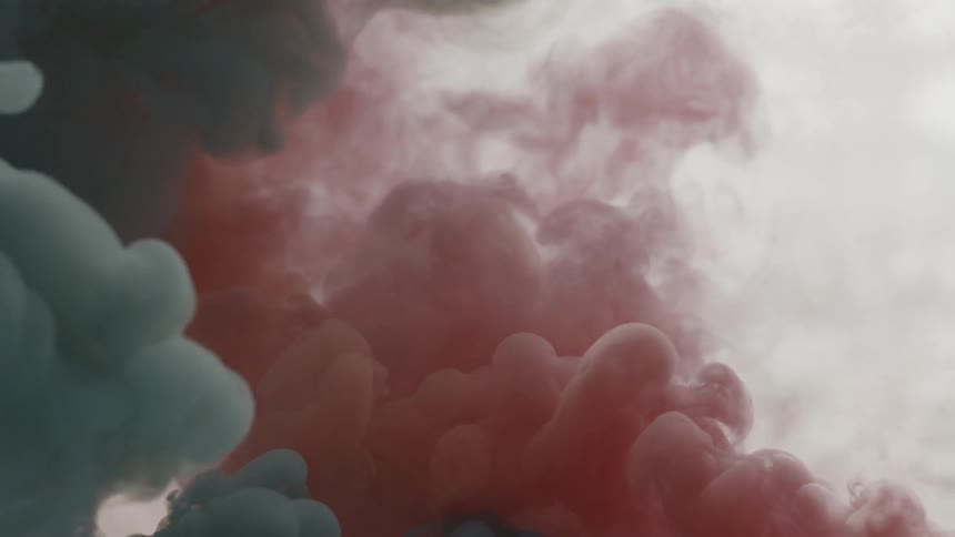 Blue and red smoke are slowly mixing together