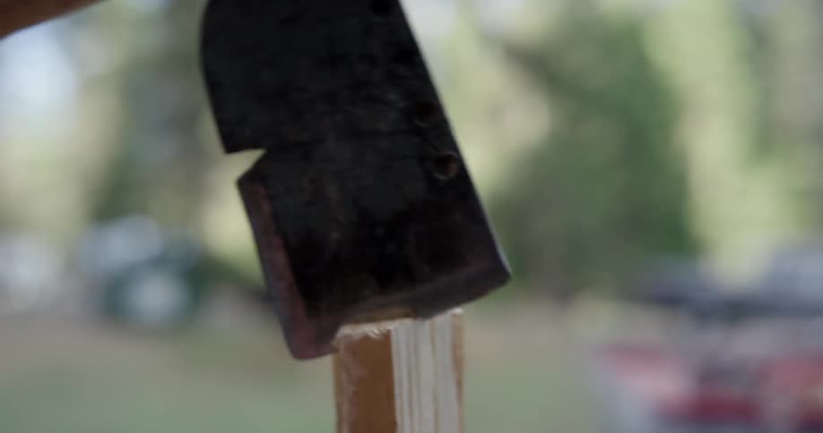 A wood splinter being worked with an axe