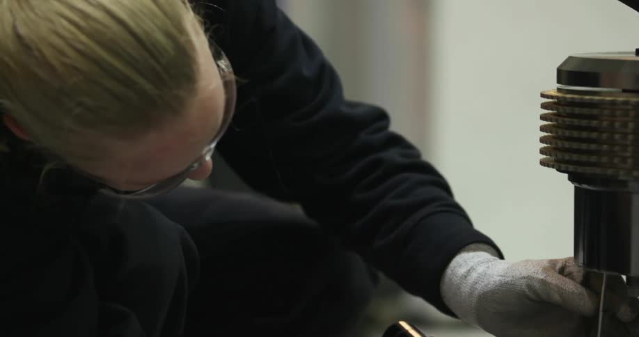 A person works on a piece of equipment
