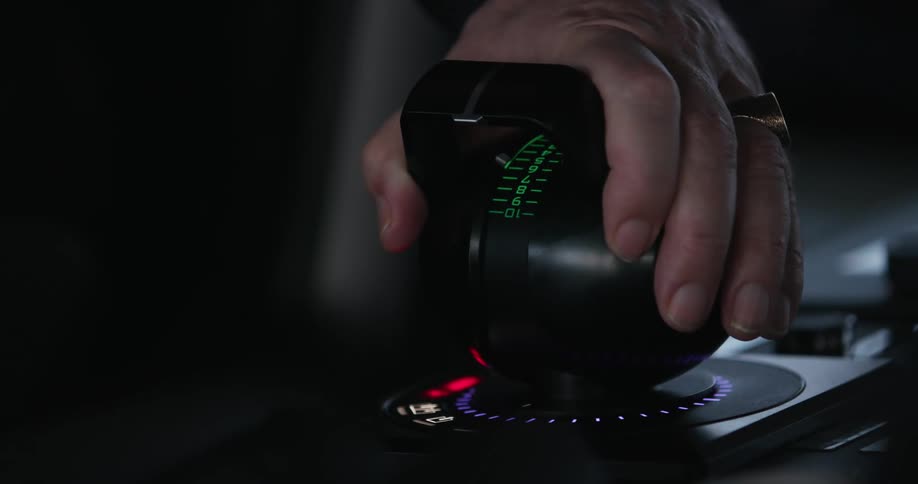 Mans hand carefully adjusts setting using labeled control