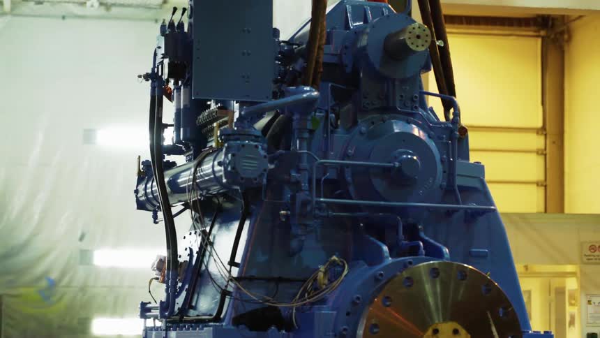 A piece of equipment moves across a factory