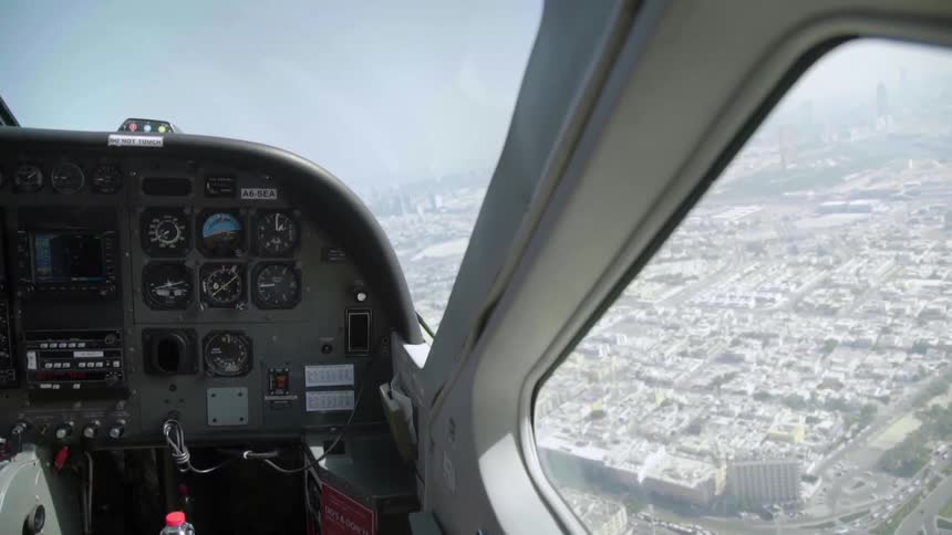 A helicopter flies over a large urban area