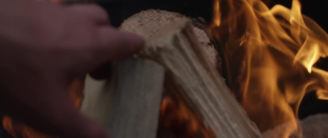 Logs are being placed in a fire
