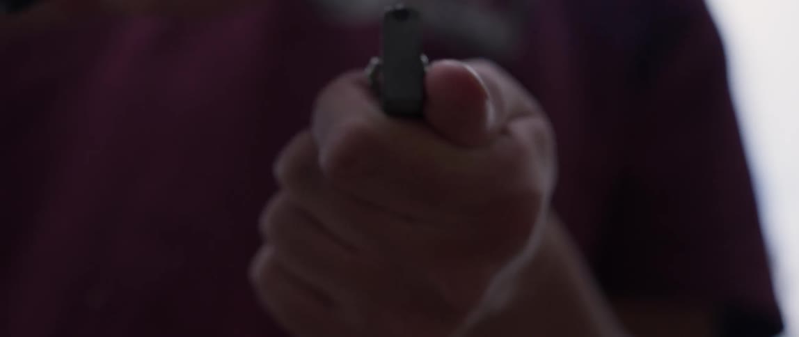 Person making sparks by scraping a knife against a piece of metal