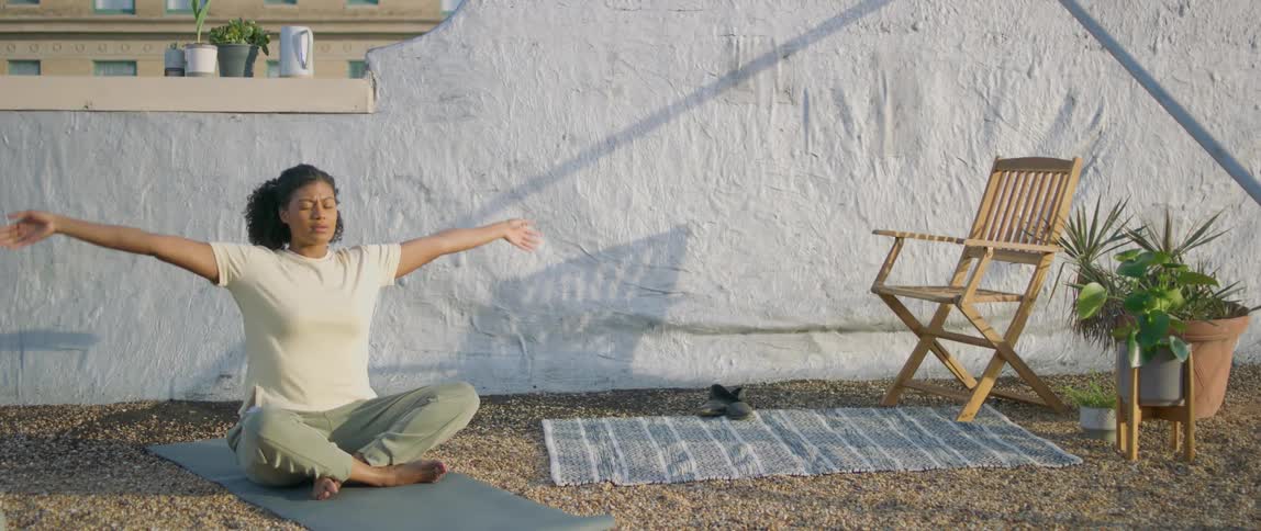 Woman practices yoga on an exercise mat