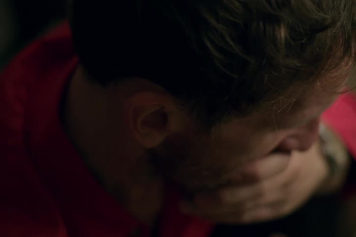 Tired man rubs his face with his hand