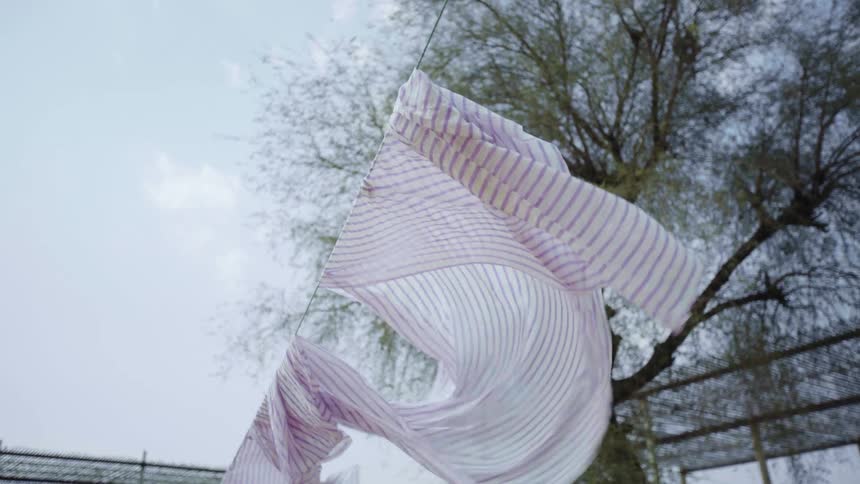 Laundry on a laundry line flapping in the wind
