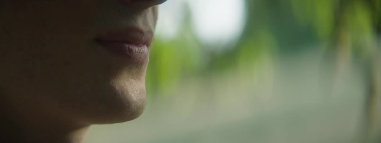 The mouth of a person outdoors on a sunny day