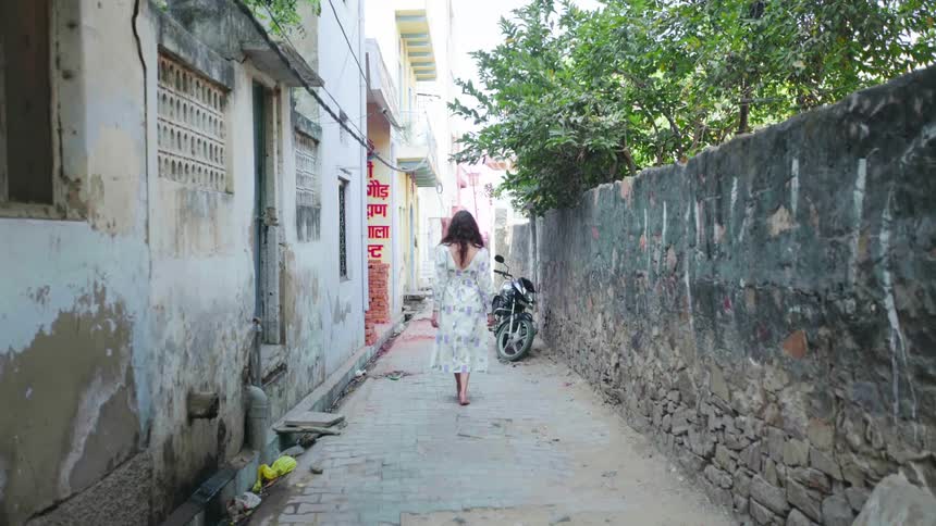 Woman walks barefoot in the alley