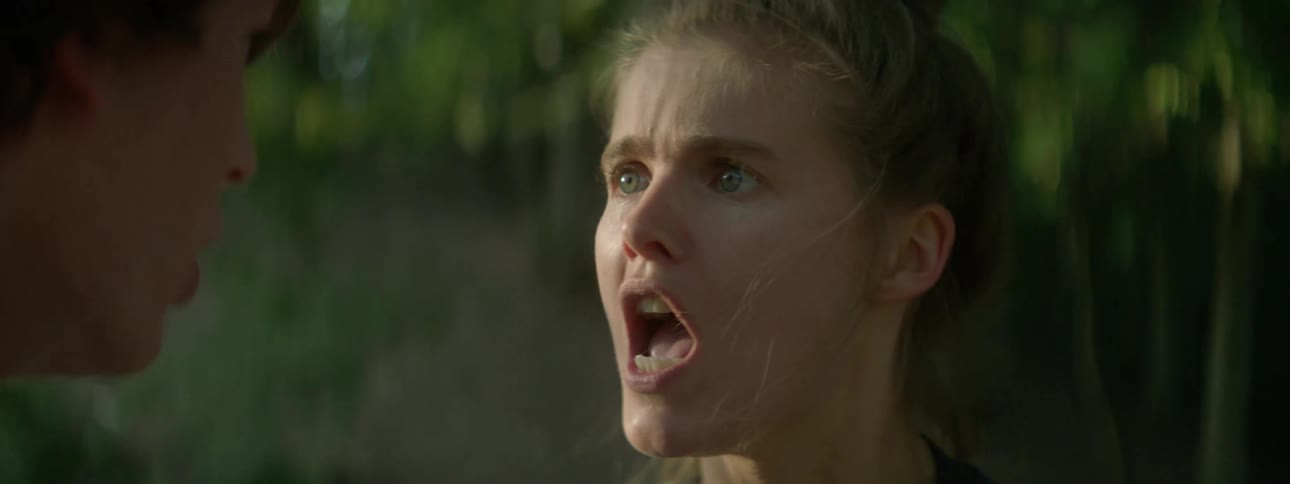 Angry girlfriend in an argument and yelling at boyfriend outdoors