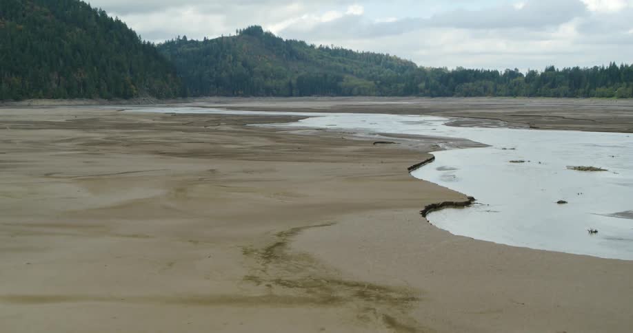 A wide expanse of beach with pools of shallow water