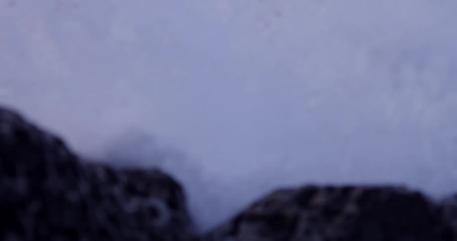 Ocean waves crash over the rocks