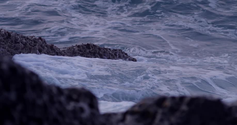 Ocean waves crash against the rock