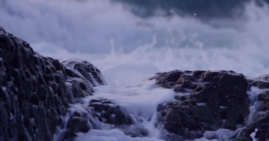 Ocean waves crash against rocks