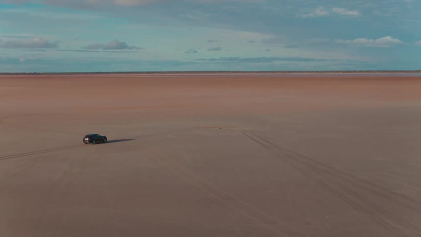 A car drives across the desert