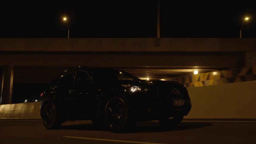 A car drives down a city street