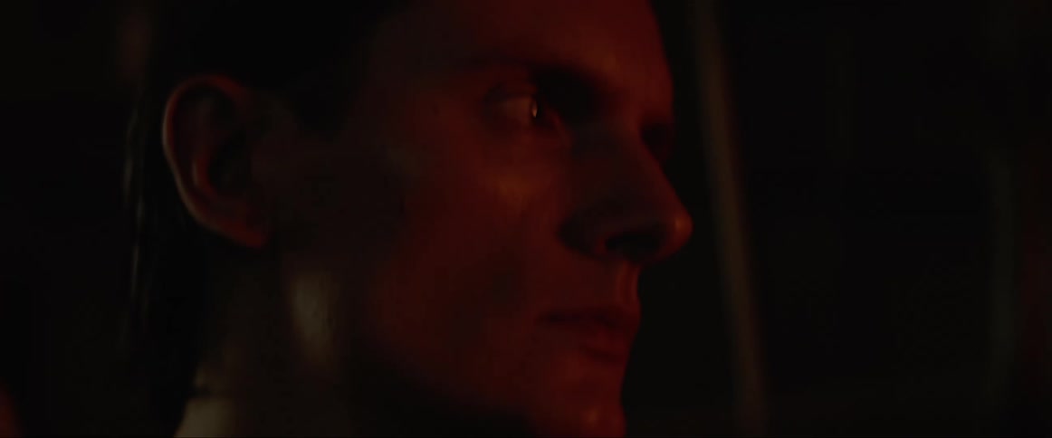A man stands outside a window and spies inside