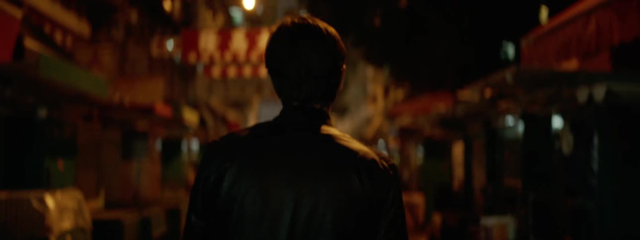 Man walks down the street at night