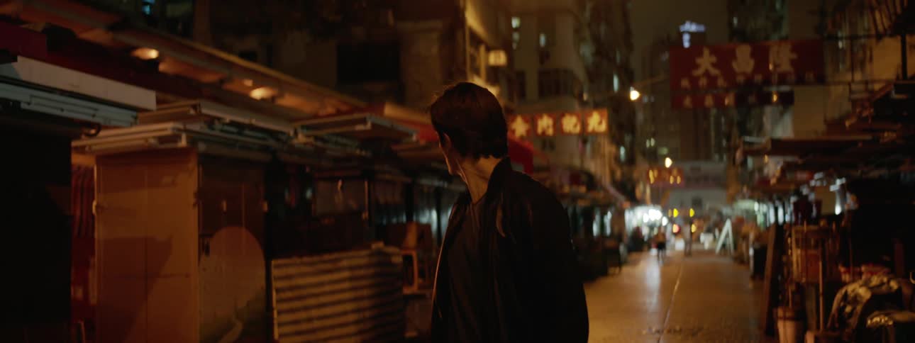 Man walks down the street at night