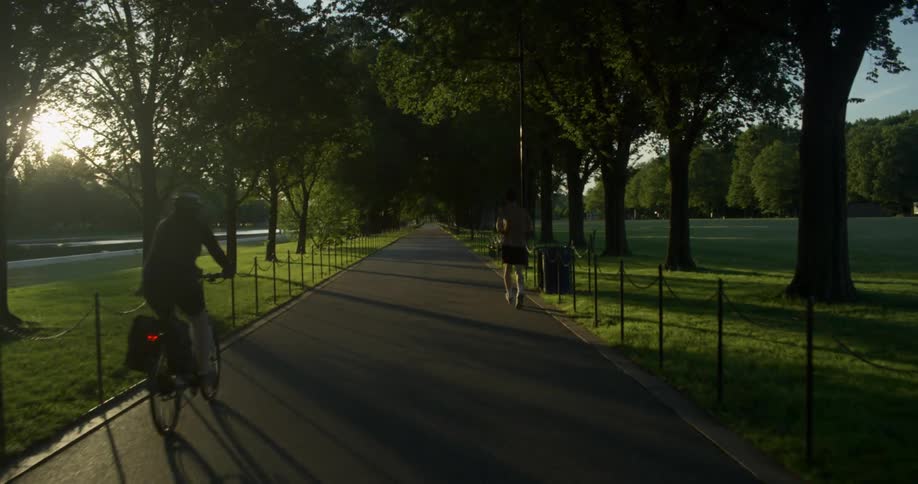 Man runs on the road in the public park