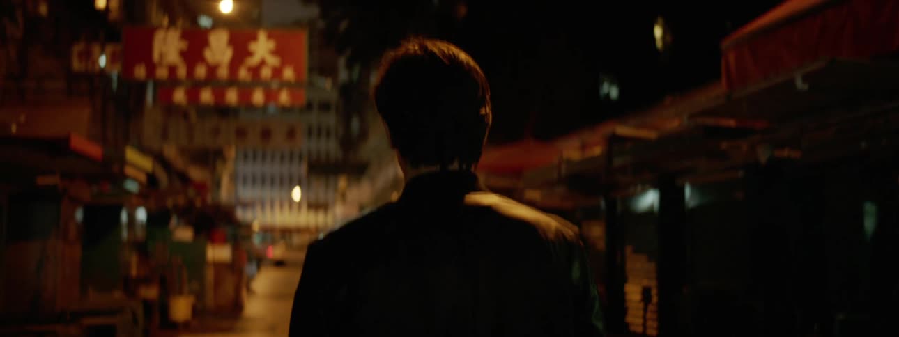 Man walks down the street at night