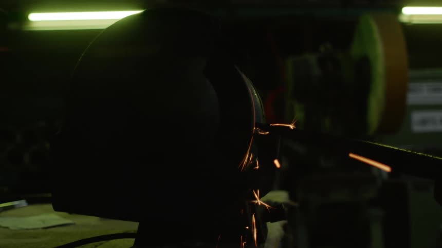 Sparks fly as a welding grinder cuts into metal
