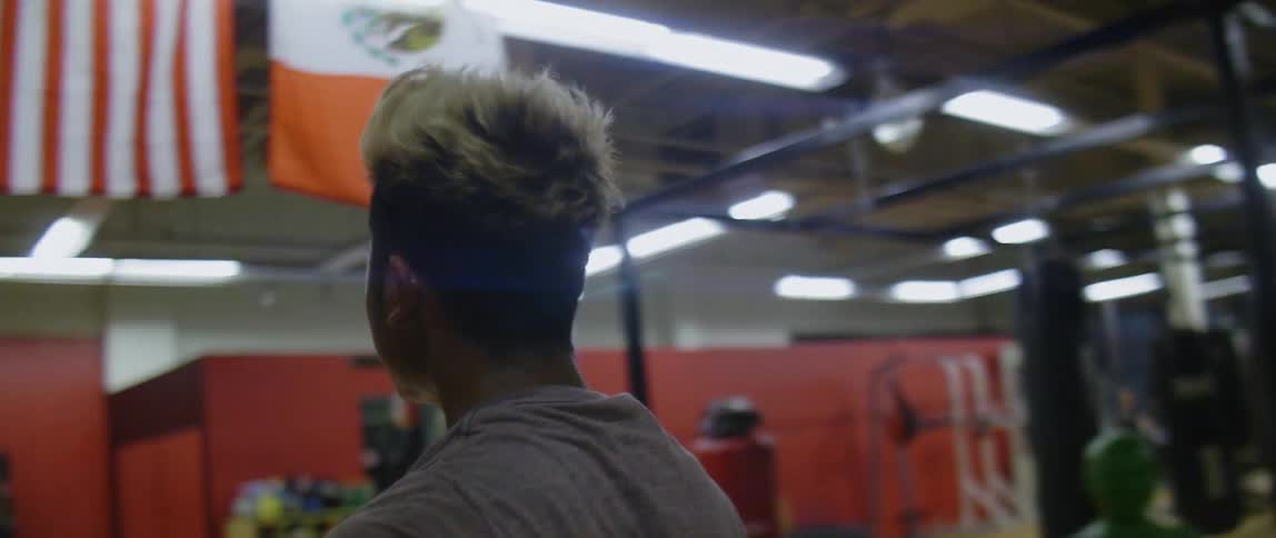 A teenager gets up to join a group of people about to exercise