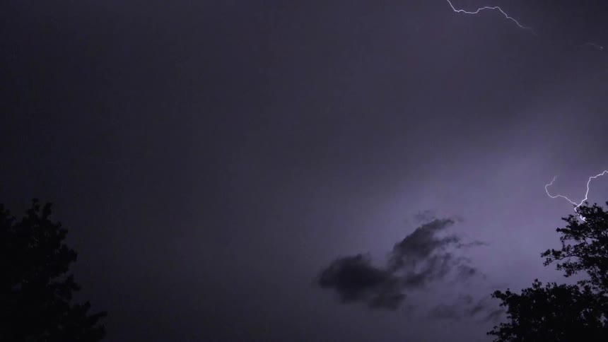 Lightning arcs across a night sky