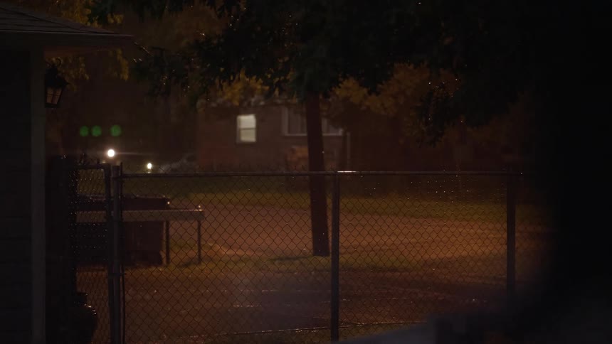 Lightning from a storm lights up a homes backyard