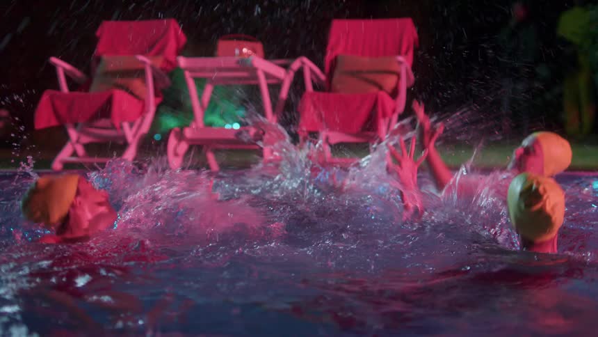 White woman synchronize swim in an outdoor pool