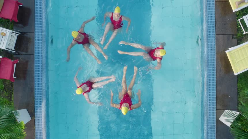 Synchronized swimmers spin and pose in a pool