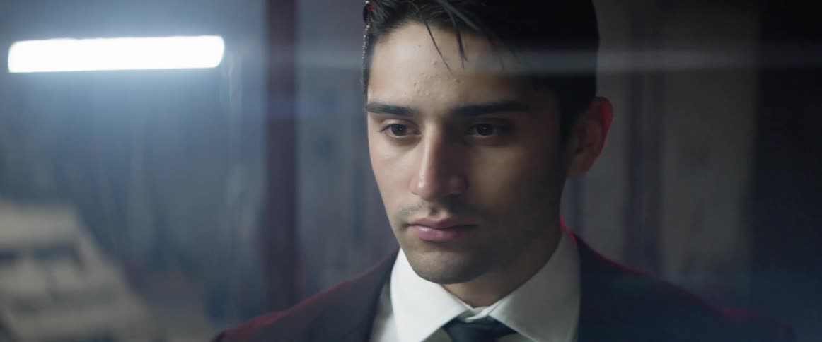 A man walks and faces forward in a room