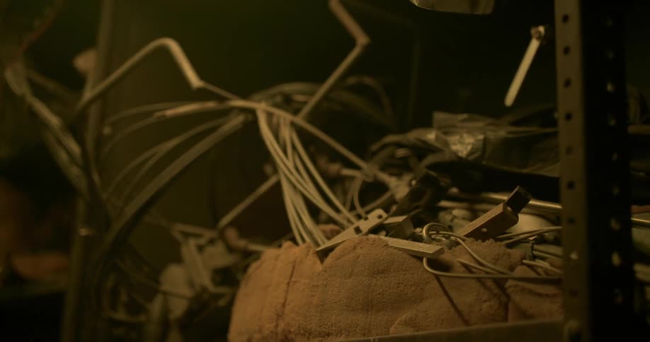 A shelving unit holding wires and power supplies