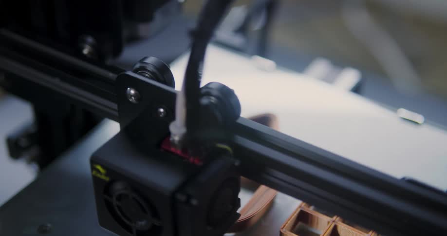 A 3d printer creates a couple of small objects